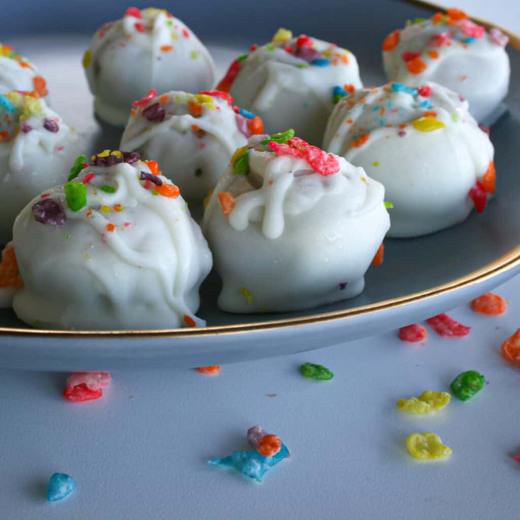 Close up photo of Fruity Pebble Truffles on a blue plate